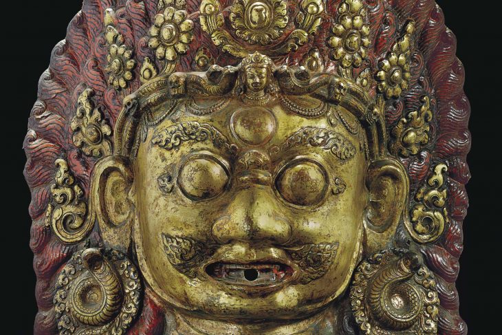 A GILT-COPPER REPOUSSE MASK OF BHAIRAVA