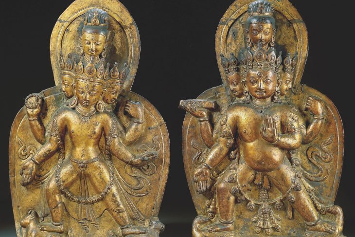 TWO GILT-COPPER REPOUSSE ORNAMENTAL PLAQUES DEPICTING SHIVA AND BHAIRAVA