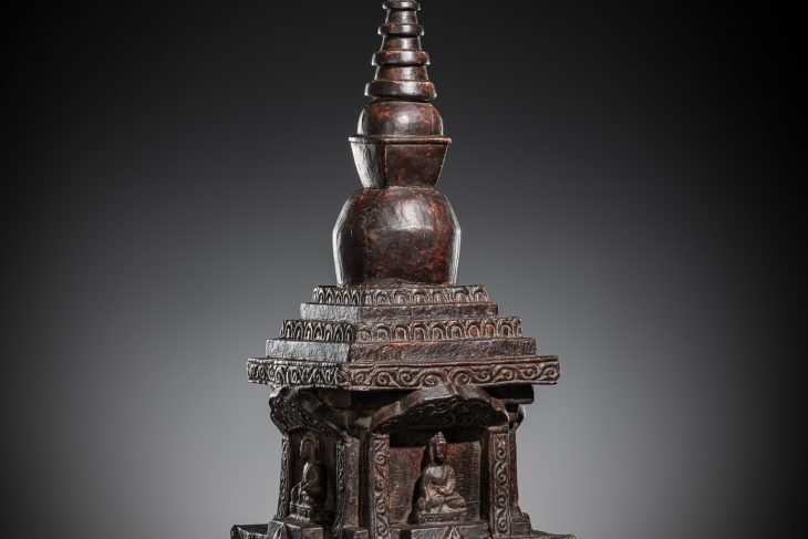 A LARGE CARVED AND LACQUERED WOOD ‘FOUR BUDDHA’ DIRECTIONAL STUPA